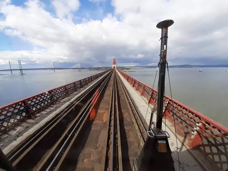 Fugro's RILA� train-mounted survey system is connected to front of the locomotive and is surveying the tracks along the Forth Bridge, Scotland