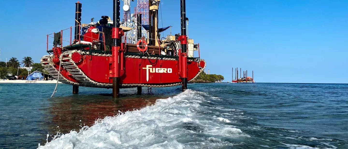The Fugro Amphibious Buggy (FAB) in action during the drilling of one of the shallow water boreholes along the transitional water zones of Male, Maldives. In the far, two most important drilling platforms owned by Fugro, Versa 1 and Oceanus are operational to deliver the services in one of the major geotechnical projects across the MEI region.